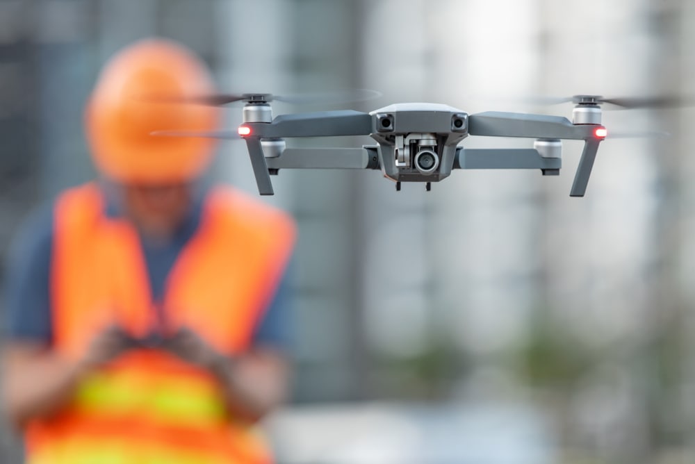 Engineer flying drone over construction site