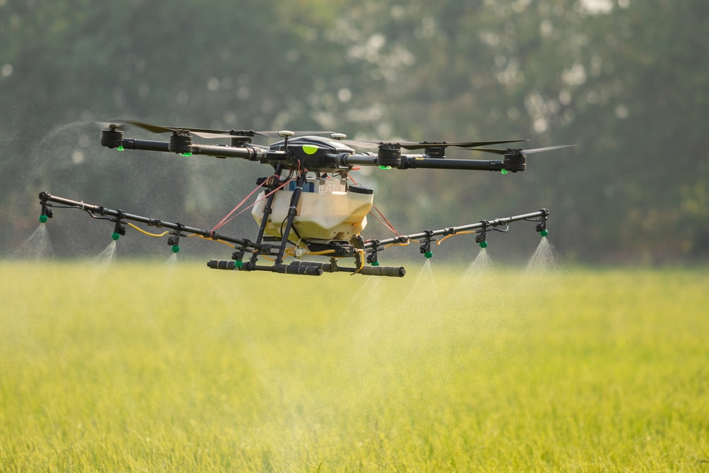 Large Agriculture Drone flying over rice field to spray crops